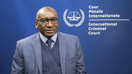 PASP, H.E. Sidiki Kaba, in front of ICC flag